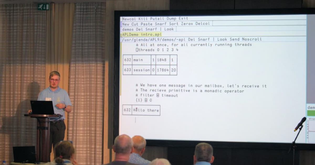 Peter Mikkelsen presenting at Dyalog '22 in Olhão, Portugal, demonstrating message passing in APL9 with a terminal-style interface projected behind him showing thread activity and output.