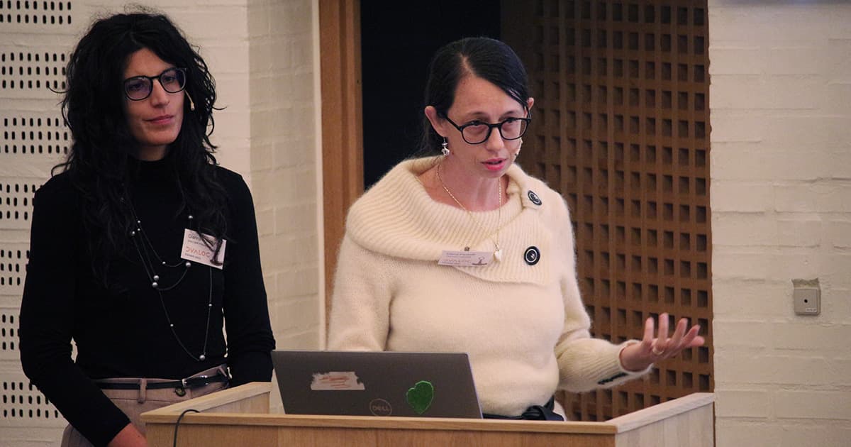 Gianna Folladore (left) and Elena Paviotti (right) presenting together at Dyalog ’23, standing at a podium with a laptop.