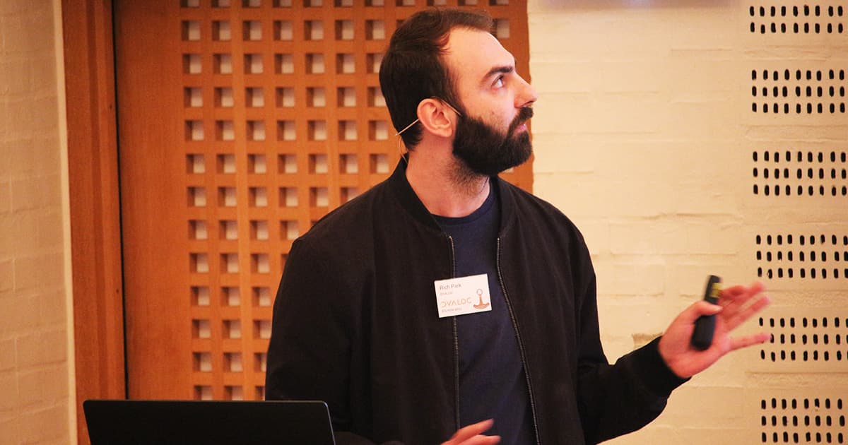 Rich Park presenting at Dyalog ’23, demonstrating an interface from Dyalog to Vega-Lite while gesturing towards the screen.