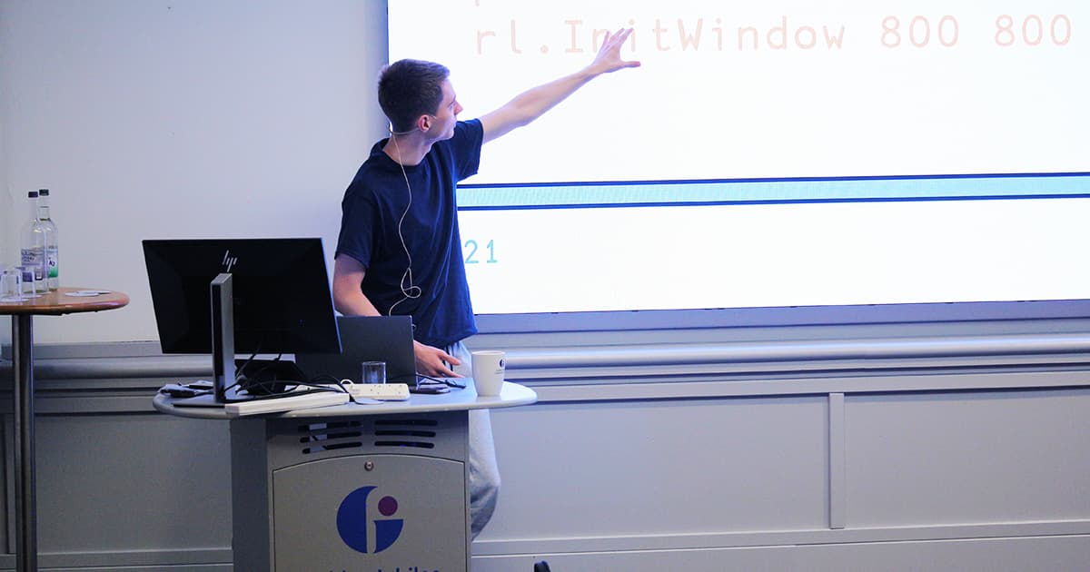Brian Ellingsgaard points to code displayed on the screen during his Dyalog ’24 presentation at the Golden Jubilee Conference Hotel.