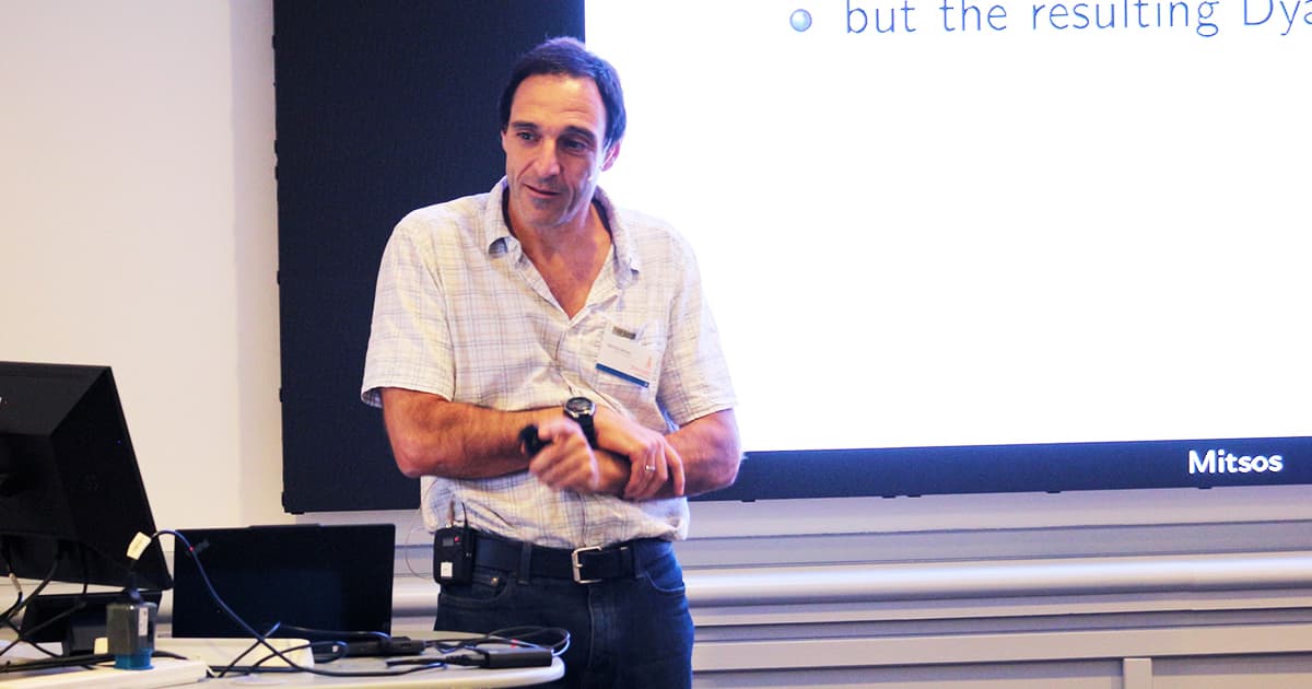 Markos Mitsos giving his talk at Dyalog ’24 in Glasgow, standing in front of a screen displaying his slides.
