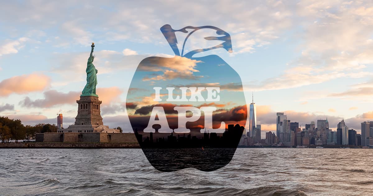 Statue of Liberty and Manhattan skyline at sunset, with a large apple-shaped overlay centered over the city that reads ‘I LIKE APL’.